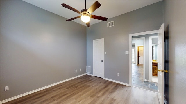 10020 Richard Cir, Forney, TX 75126 - unfurnished bedroom with baseboards, visible vents, a high ceiling, and wood finished floors
