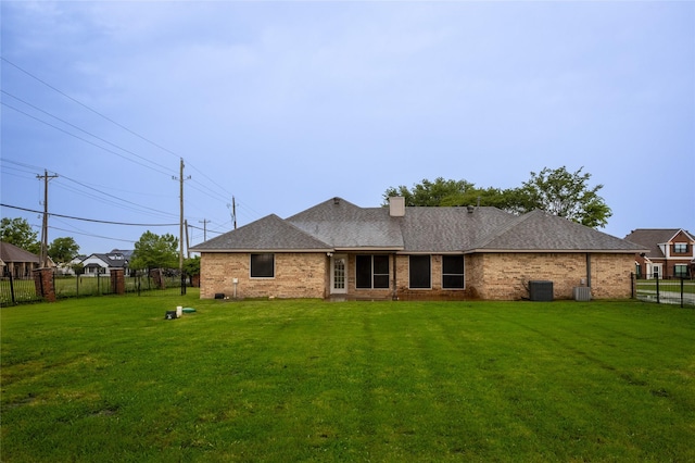 10020 Richard Cir, Forney, TX 75126 - back of property featuring central air condition unit, fence, a chimney, and a lawn