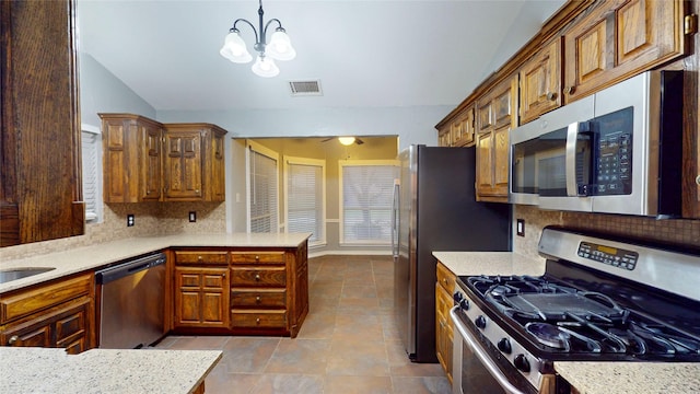 10020 Richard Cir, Forney, TX 75126 - kitchen with a peninsula, appliances with stainless steel finishes, visible vents, and tasteful backsplash