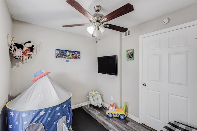 game room with baseboards, visible vents, wood finished floors, and a ceiling fan