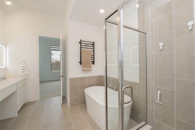 9415 Royal Forest Dr, Oak Point, TX 75068 - full bathroom featuring vanity, a soaking tub, a shower stall, tile walls, and tile patterned floors
