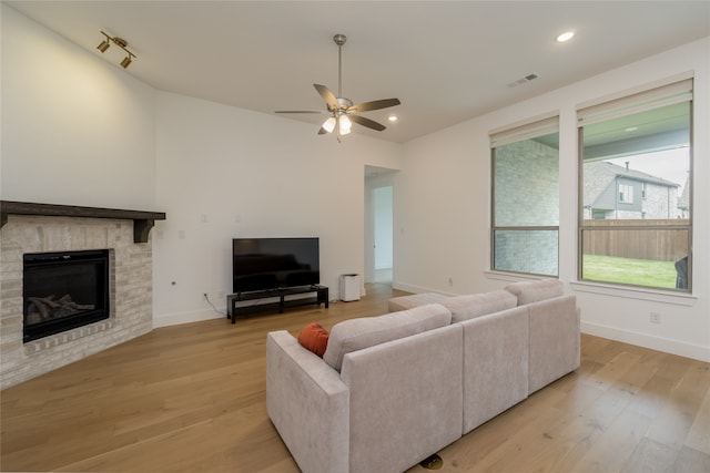 9415 Royal Forest Dr, Oak Point, TX 75068 - living room with a ceiling fan, light wood-style floors, a glass covered fireplace, baseboards, and recessed lighting