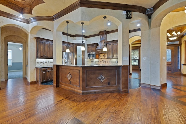 1206 Genesis Dr, Mansfield, TX 76063 - kitchen with crown molding, decorative backsplash, arched walkways, dark wood-style floors, and appliances with stainless steel finishes