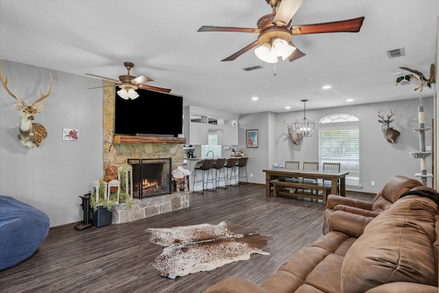 200 County Road 1574, Alba, TX 75410 - living room featuring a stone fireplace, visible vents, and ceiling fan with notable chandelier