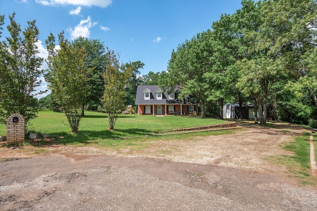 200 County Road 1574, Alba, TX 75410 - view of front of house featuring a storage shed, a front lawn, an outbuilding, and driveway