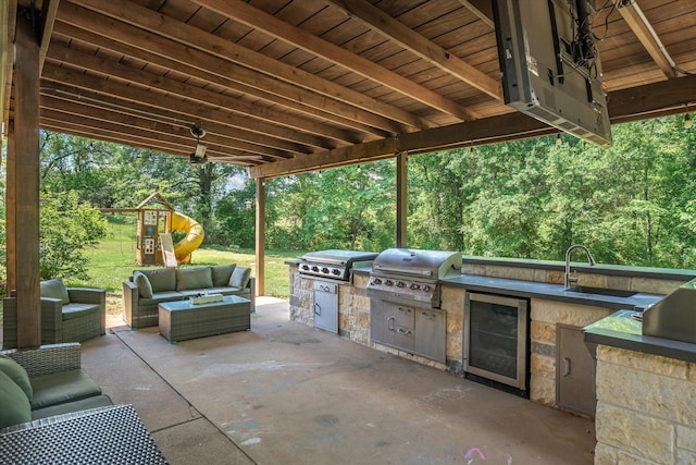 200 County Road 1574, Alba, TX 75410 - view of patio / terrace with grilling area, an outdoor hangout area, exterior kitchen, and beverage cooler