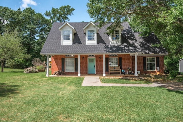 200 County Road 1574, Alba, TX 75410 - new england style home with roof with shingles, a porch, brick siding, and a front lawn