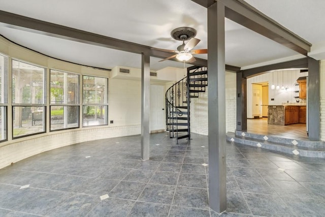 2328 Wildwood Way, Tool, TX 75143 - unfurnished living room featuring beamed ceiling, stairway, a ceiling fan, and dark tile patterned floors