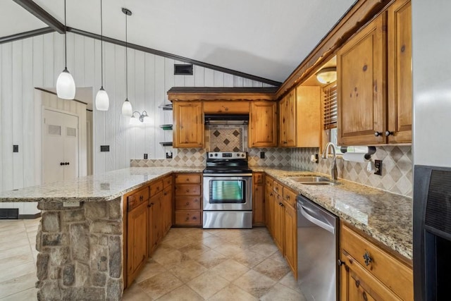 2328 Wildwood Way, Tool, TX 75143 - kitchen with appliances with stainless steel finishes, a sink, brown cabinetry, vaulted ceiling, and a peninsula