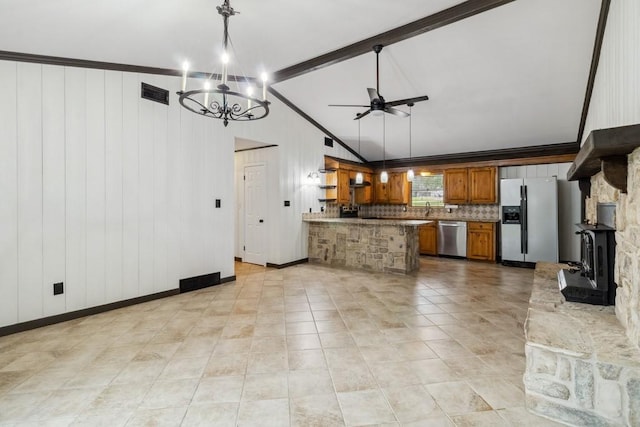 2328 Wildwood Way, Tool, TX 75143 - kitchen featuring appliances with stainless steel finishes, brown cabinetry, a peninsula, and decorative light fixtures