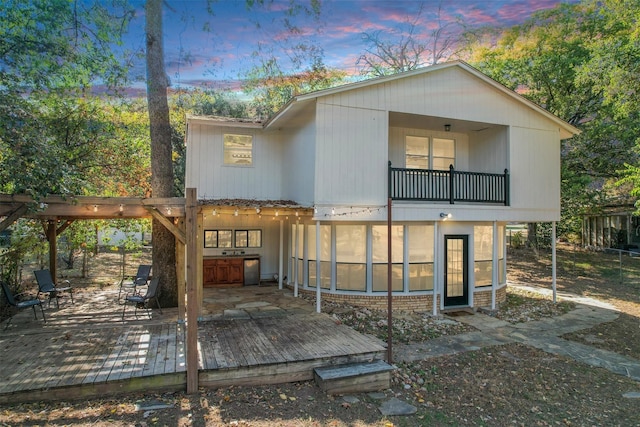 2328 Wildwood Way, Tool, TX 75143 - back of house at dusk with a balcony and a deck