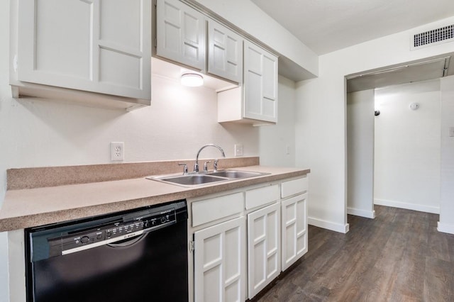 2210 Sheriff Dr, Grand Prairie, TX 75051 - kitchen with dishwasher, a sink, dark wood-type flooring, light countertops, and white cabinets