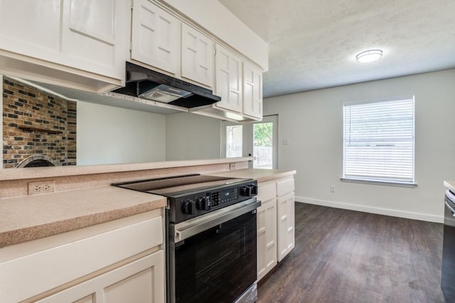 2210 Sheriff Dr, Grand Prairie, TX 75051 - kitchen with electric range oven, baseboards, dark wood-type flooring, light countertops, and white cabinets