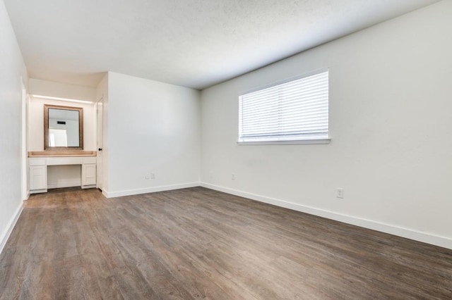 2210 Sheriff Dr, Grand Prairie, TX 75051 - unfurnished bedroom featuring dark wood-style floors and baseboards