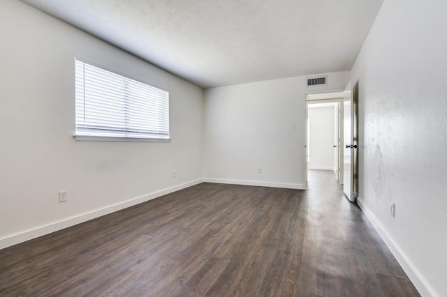 2210 Sheriff Dr, Grand Prairie, TX 75051 - empty room with dark wood finished floors and baseboards