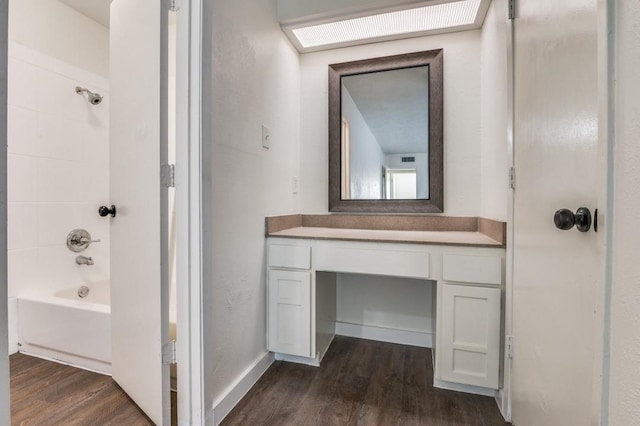 2210 Sheriff Dr, Grand Prairie, TX 75051 - full bath with wood finished floors, vanity, and shower / bathtub combination