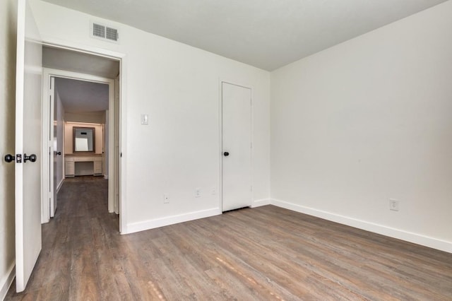 2210 Sheriff Dr, Grand Prairie, TX 75051 - unfurnished bedroom featuring baseboards and wood finished floors
