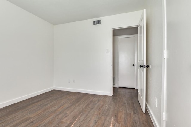 2210 Sheriff Dr, Grand Prairie, TX 75051 - spare room with dark wood-style flooring and baseboards