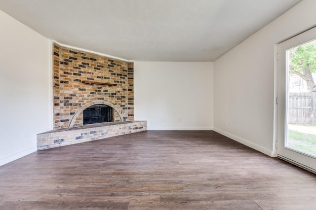 2210 Sheriff Dr, Grand Prairie, TX 75051 - unfurnished living room with wood finished floors, baseboards, and a fireplace