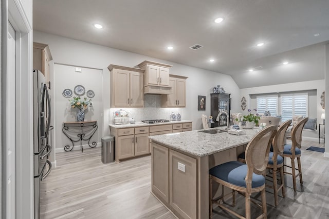 1076 Fleetwood Dr, Justin, TX 76247 - kitchen with appliances with stainless steel finishes, a sink, a fireplace, a ceiling fan, and a kitchen island with sink