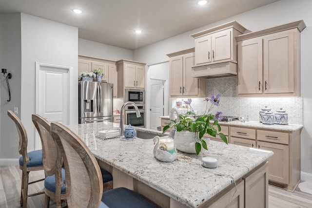 1076 Fleetwood Dr, Justin, TX 76247 - kitchen with stainless steel appliances, premium range hood, tasteful backsplash, a kitchen breakfast bar, and light stone counters