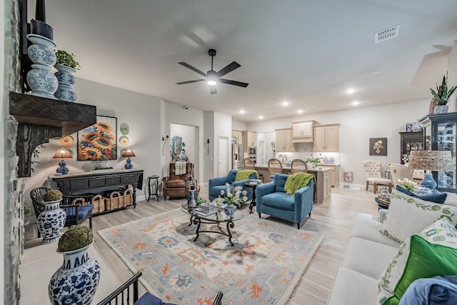 1076 Fleetwood Dr, Justin, TX 76247 - living area with ceiling fan, healthy amount of natural light, a fireplace, and light wood-style floors