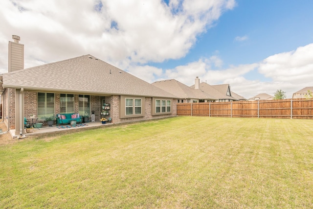 1076 Fleetwood Dr, Justin, TX 76247 - back of property with a chimney, a patio area, a shingled roof, brick siding, and an outdoor hangout area