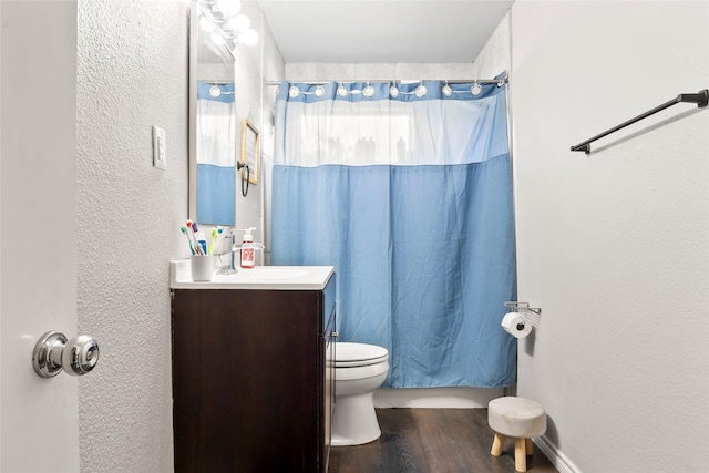 3100 Karla, Mesquite, TX 75150 - full bath with a textured wall, vanity, wood finished floors, and toilet