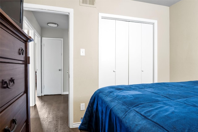3100 Karla, Mesquite, TX 75150 - bedroom featuring dark wood-type flooring, baseboards, and a closet