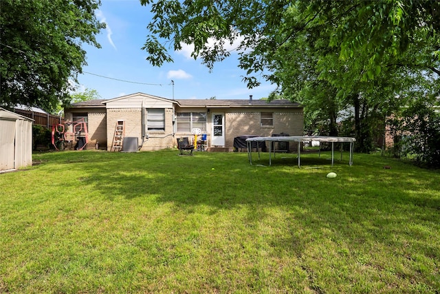 3100 Karla, Mesquite, TX 75150 - rear view of house featuring a trampoline, cooling unit, a storage shed, and brick siding