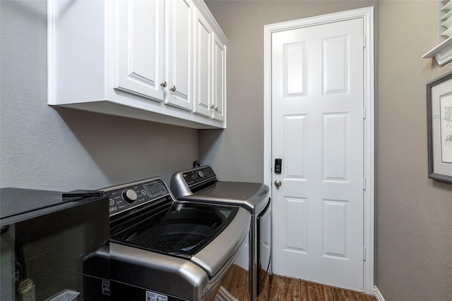 3528 Clubgate Dr, Fort Worth, TX 76137 - laundry area with washer and clothes dryer, dark wood-style flooring, cabinet space, and baseboards