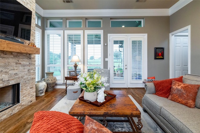3528 Clubgate Dr, Fort Worth, TX 76137 - living room featuring visible vents, a fireplace, crown molding, and wood finished floors