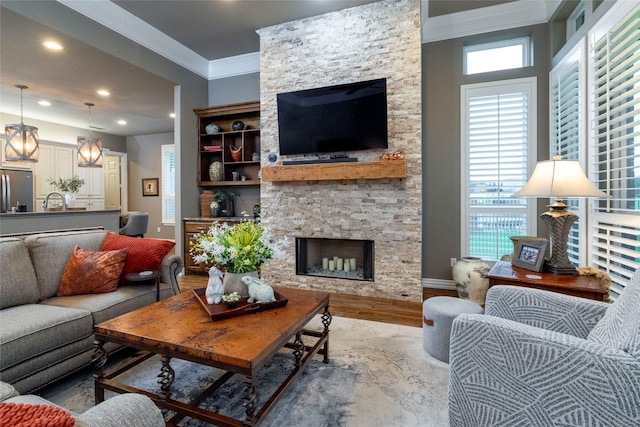 3528 Clubgate Dr, Fort Worth, TX 76137 - living area with recessed lighting, baseboards, a stone fireplace, ornamental molding, and wood finished floors