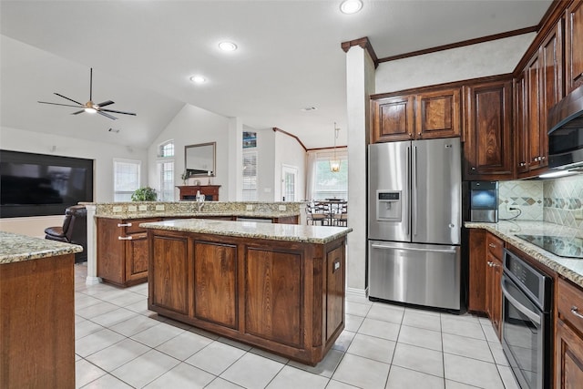 209 Odyssey Ln, Mansfield, TX 76063 - kitchen featuring ceiling fan, a center island, stainless steel appliances, and a healthy amount of sunlight
