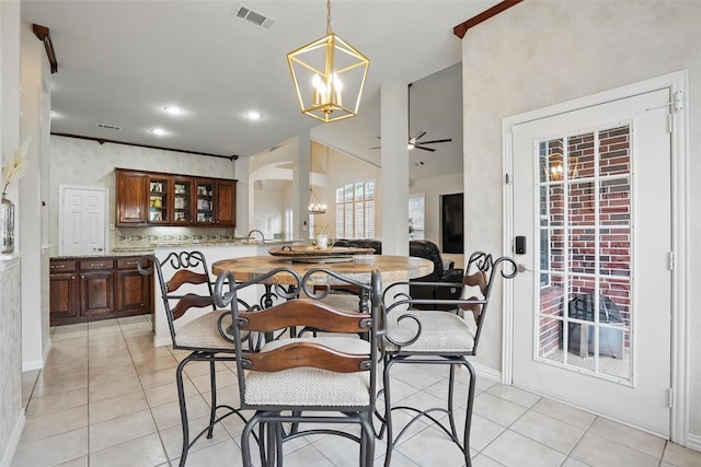 209 Odyssey Ln, Mansfield, TX 76063 - dining room with ceiling fan with notable chandelier, light tile patterned flooring, visible vents, arched walkways, and baseboards