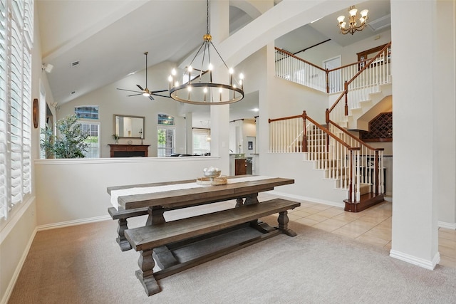 209 Odyssey Ln, Mansfield, TX 76063 - dining room with high vaulted ceiling, stairway, a fireplace, light carpet, and baseboards