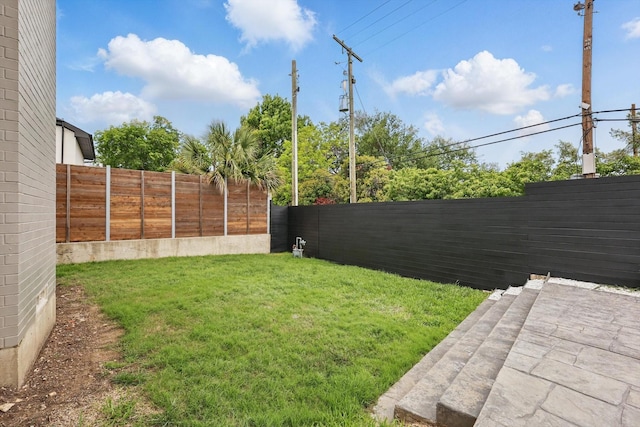 view of yard with a fenced backyard
