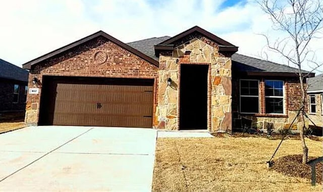 view of front of house featuring stone siding, concrete driveway, brick siding, and a garage