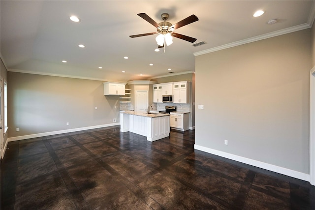 250 Martis Way, Abilene, TX 79602 - kitchen with appliances with stainless steel finishes, baseboards, ornamental molding, a sink, and an island with sink