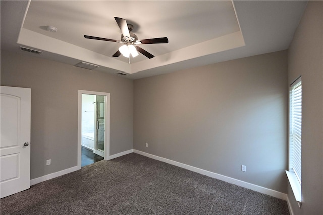 250 Martis Way, Abilene, TX 79602 - spare room with baseboards, dark colored carpet, visible vents, ceiling fan, and a raised ceiling