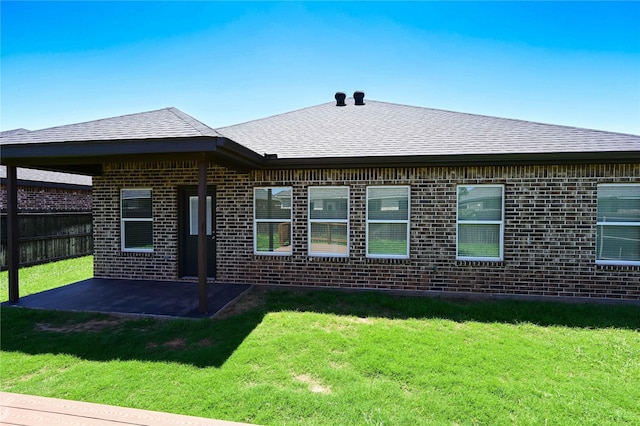 250 Martis Way, Abilene, TX 79602 - rear view of property featuring a yard, brick siding, fence, a patio area, and roof with shingles