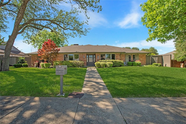 single story home featuring brick siding and a front lawn