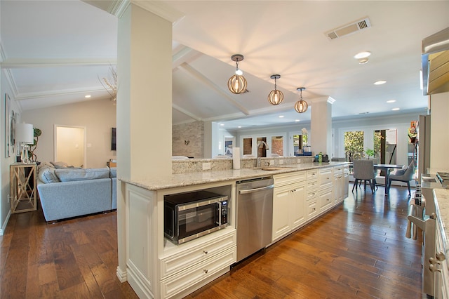 kitchen with appliances with stainless steel finishes, open floor plan, a sink, light stone counters, and crown molding