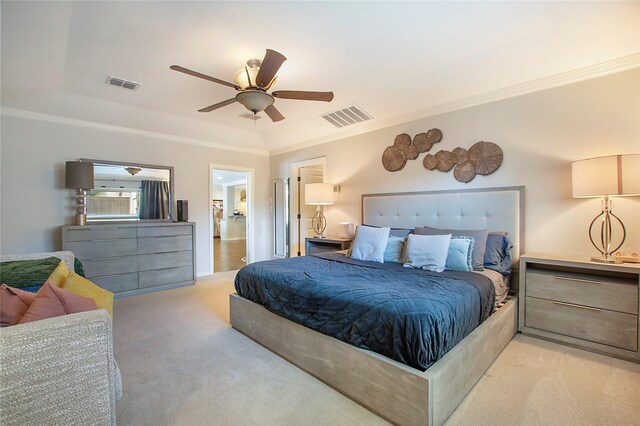 bedroom with ornamental molding, light colored carpet, and a ceiling fan