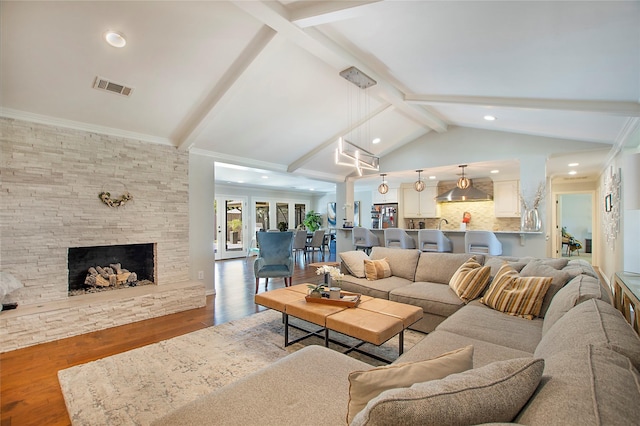 living area featuring wood finished floors, recessed lighting, and a stone fireplace