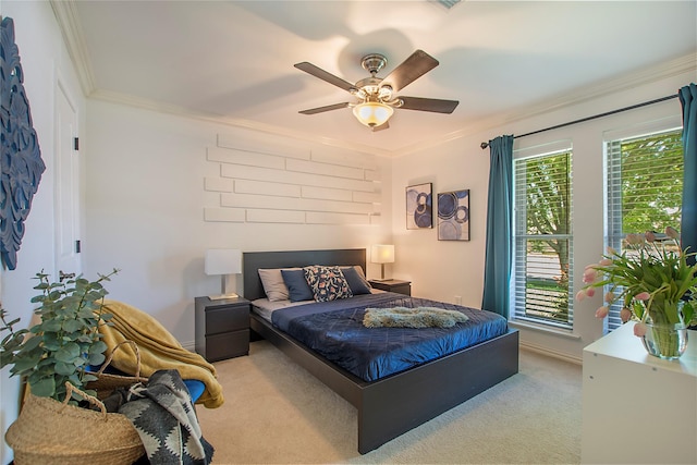 carpeted bedroom featuring crown molding, ceiling fan, and baseboards