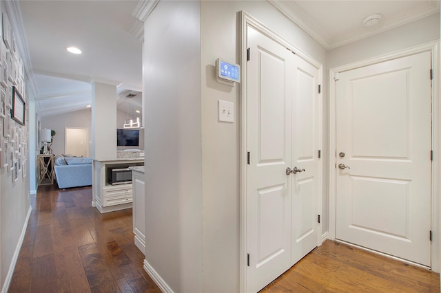 hall with dark wood-style flooring, ornamental molding, baseboards, and recessed lighting