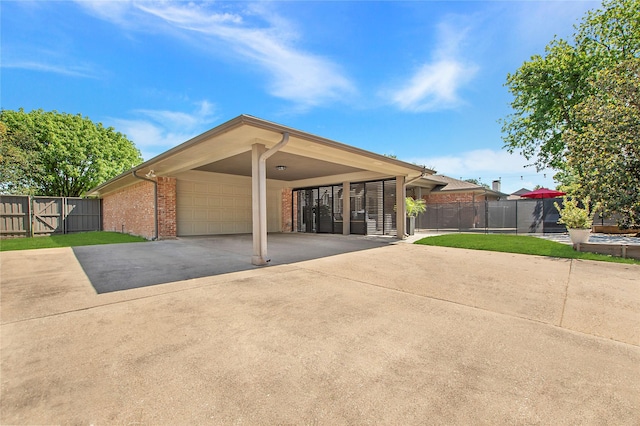 single story home with a carport, concrete driveway, fence, and brick siding