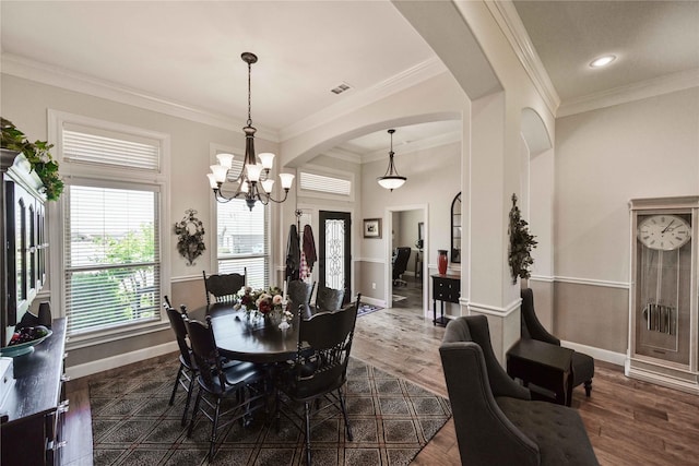 8301 Cimarron Trl, Abilene, TX 79606 - dining room featuring baseboards, an inviting chandelier, visible vents, crown molding, and arched walkways