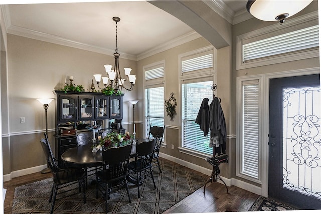 8301 Cimarron Trl, Abilene, TX 79606 - dining area featuring arched walkways, baseboards, dark wood finished floors, and an inviting chandelier